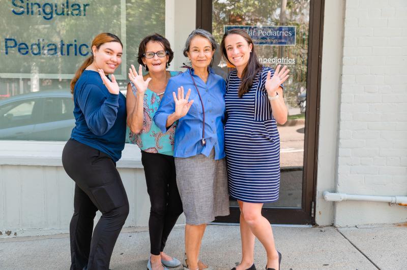 four women waving